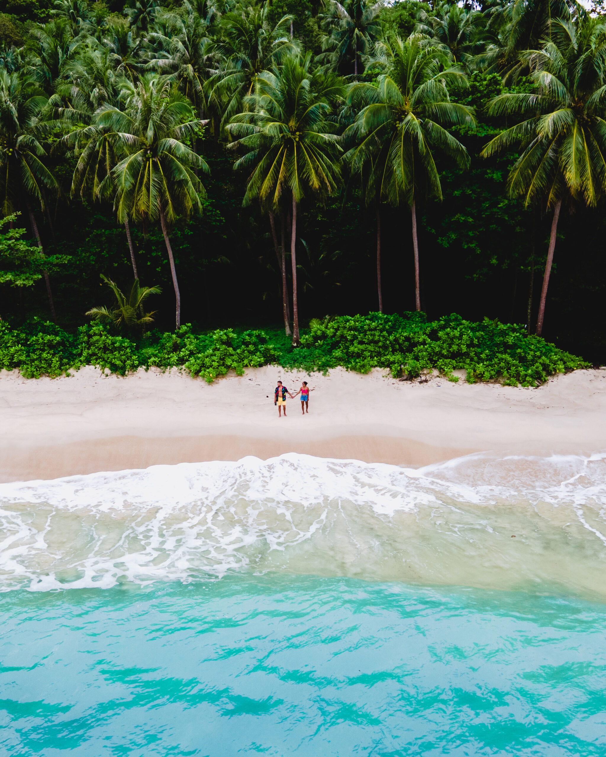 couple on beach enjoying their luxury Caribbean home