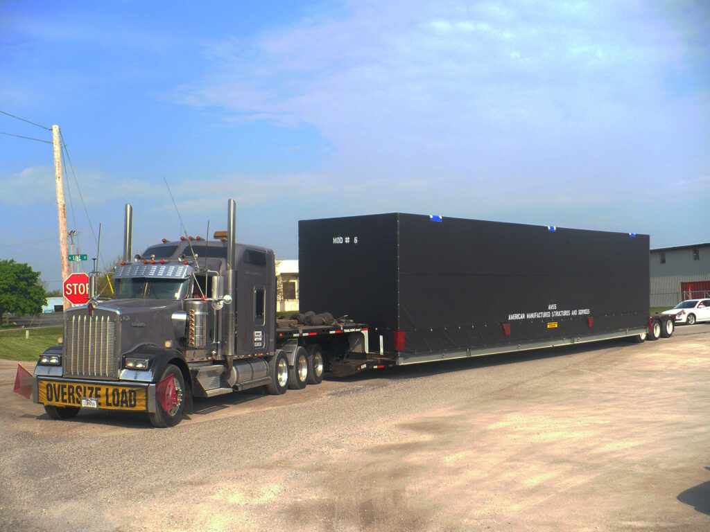 Truck carrying section of home on it's way to the Caribbean